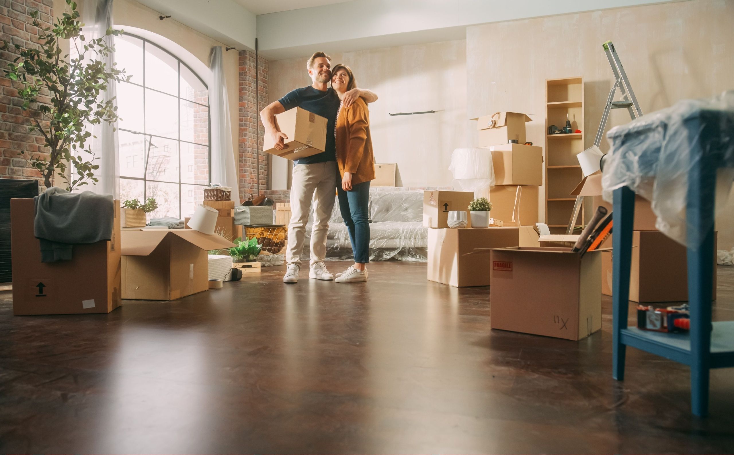 young couple unpacking boxes in a new home