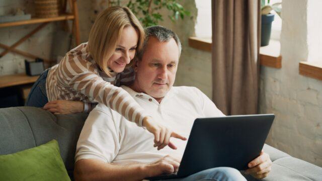 middle-aged couple using a laptop