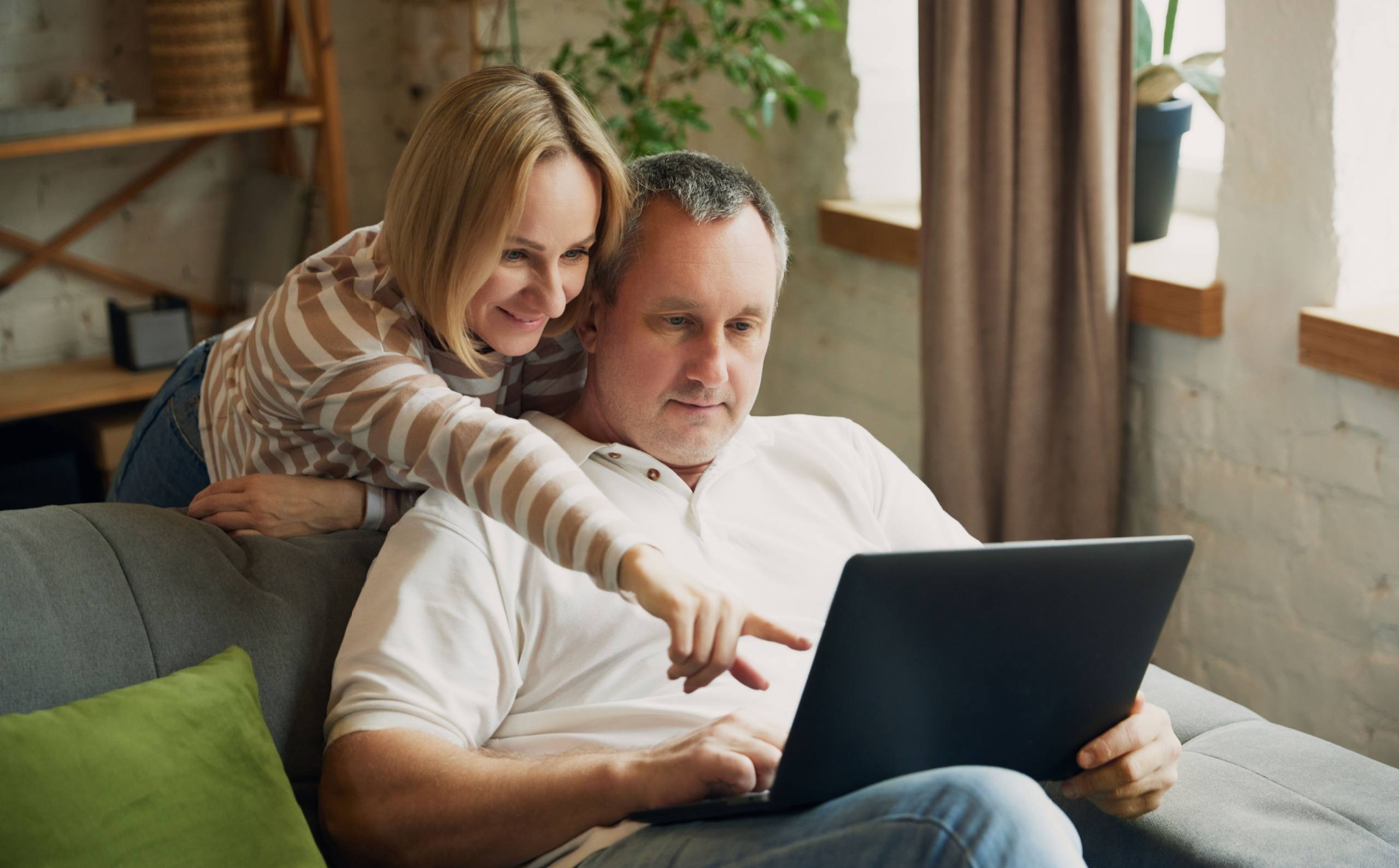 middle-aged couple using a laptop