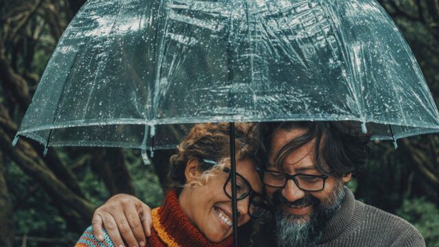 A couple under an umbrella.